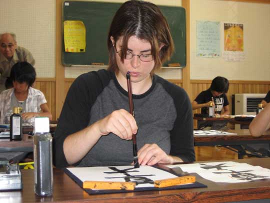 Tyffany practicing her brush calligraphy