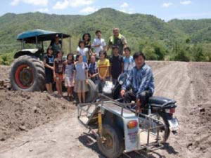 A Group of People Sitting With a Tractor