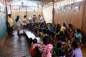 A Group of Children Sitting on the Floor in a Classroom