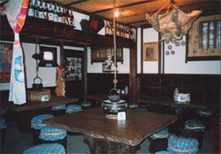 A Table With Small Blue Chairs Around